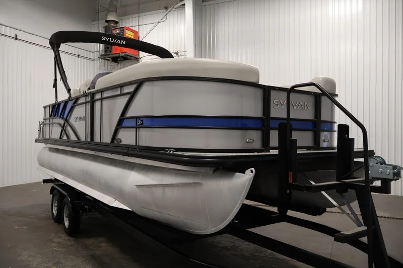 Slide: The Image of 2021 Sylvan 8522 Mirage pontoon boat on trailer in indoor storage. - 3
