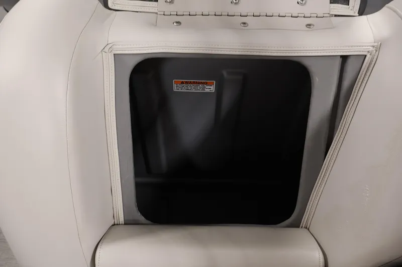 Slide: The Image of 2021 Sylvan 8522 Mirage boat seat storage compartment with warning label. - 30