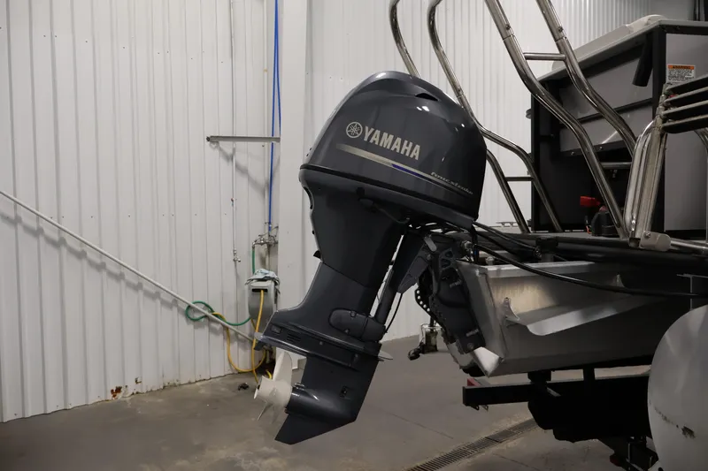 Slide: The Image of 2021 Sylvan 8522 Mirage with Yamaha outboard motor in a garage setting. - 37