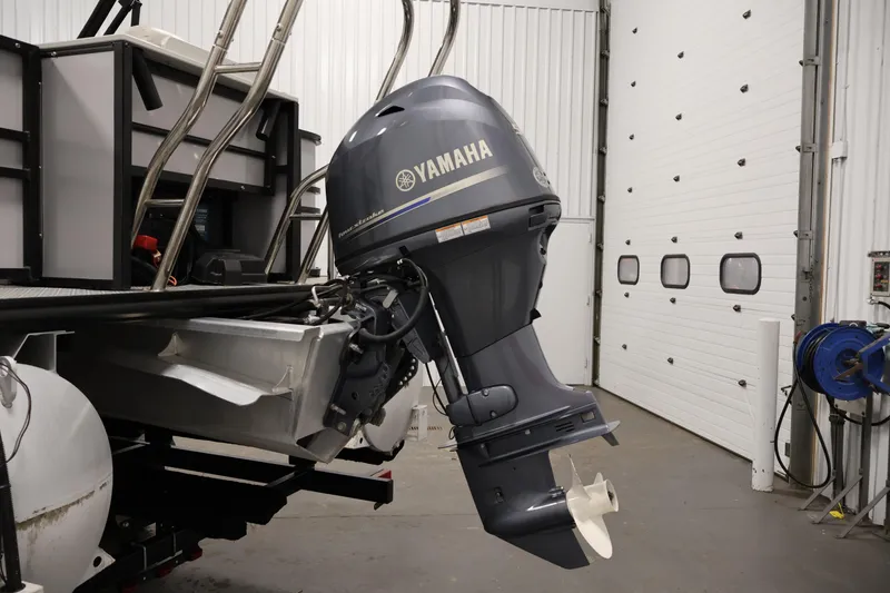 Slide: The Image of 2021 Sylvan 8522 Mirage with Yamaha outboard motor in a garage setting. - 38