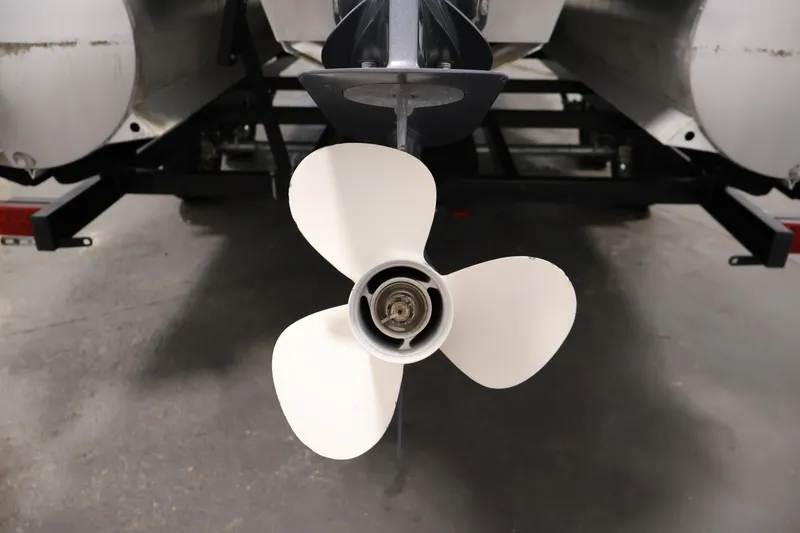 Slide: The Image of 2021 Sylvan 8522 Mirage boat propeller, close-up view in a garage setting. - 39