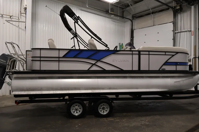 Slide: The Image of 2021 Sylvan 8522 Mirage pontoon boat in a garage, side view. - 4