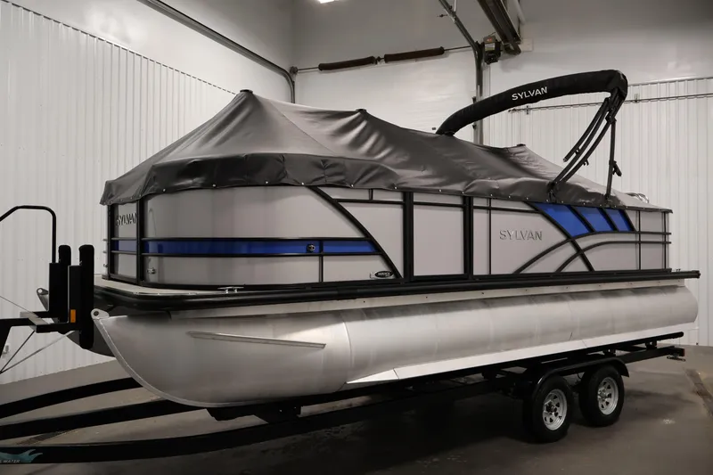 Slide: The Image of 2021 Sylvan 8522 Mirage pontoon boat with cover on trailer in garage. - 43