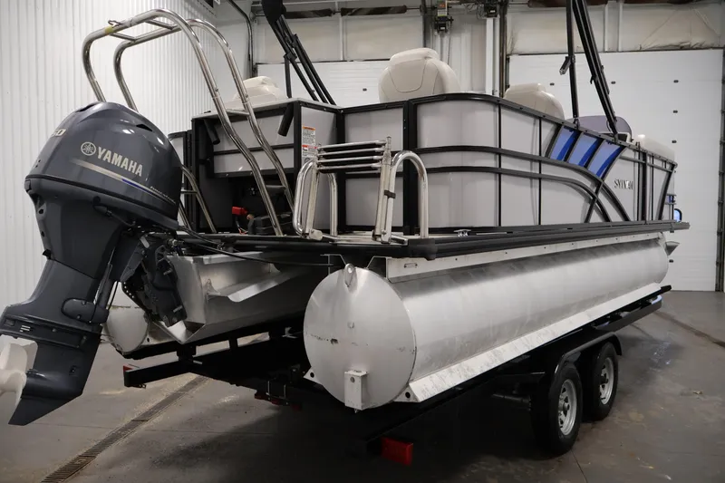 Slide: The Image of 2021 Sylvan 8522 Mirage pontoon boat with Yamaha outboard motor in a garage. - 5