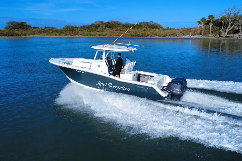 Slide: The Image of 2020 Tidewater 280 CC Adventure boat cruising on a serene lake. - 10