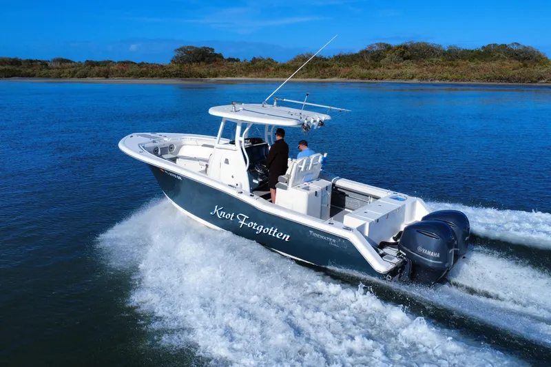 Slide: The Image of 2020 Tidewater 280 CC Adventure boat cruising on a scenic waterway. - 11