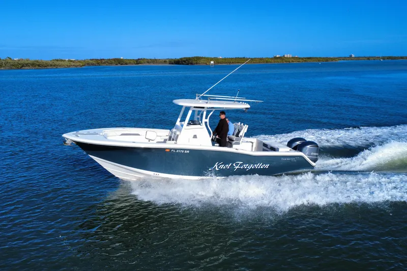 Slide: The Image of 2020 Tidewater 280 CC Adventure boat cruising on blue water. - 12