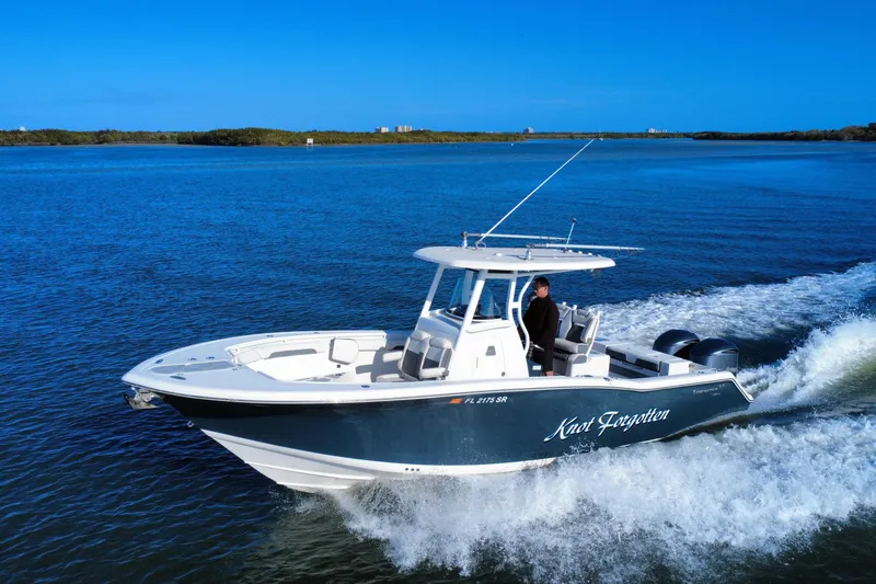Slide: The Image of 2020 Tidewater 280 CC Adventure boat cruising on blue water. - 13