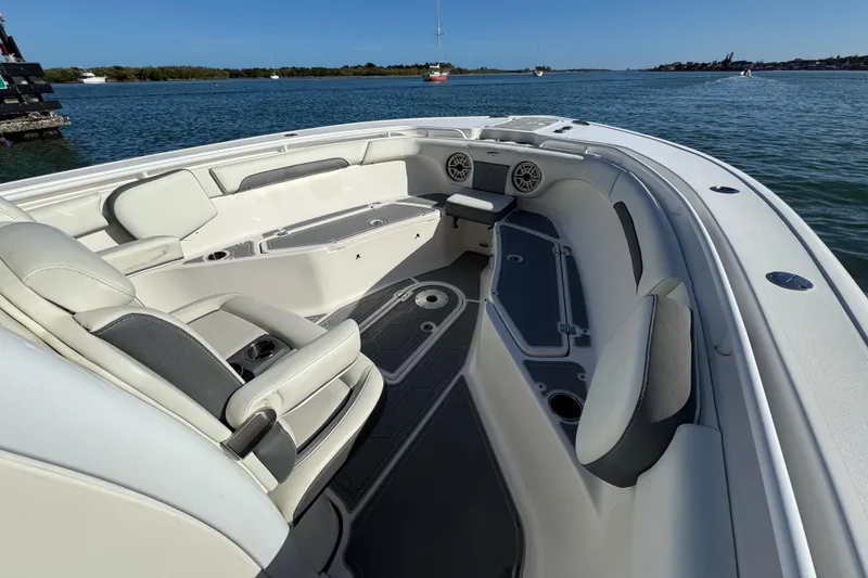 Slide: The Image of 2020 Tidewater 280 CC Adventure boat interior with seating, on a calm waterway. - 17