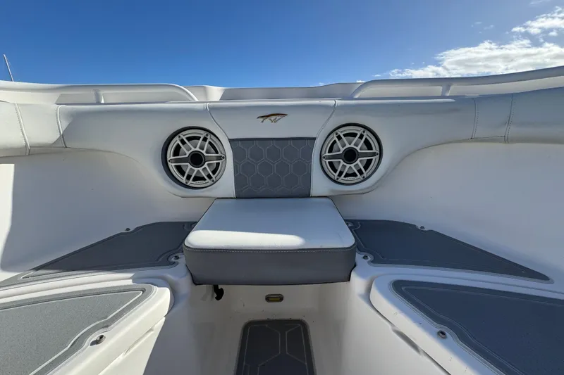 Slide: The Image of 2020 Tidewater 280 CC Adventure boat interior with speakers and seating under blue sky. - 19
