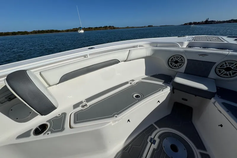 Slide: The Image of 2020 Tidewater 280 CC Adventure boat interior with seating and speakers on calm water. - 25