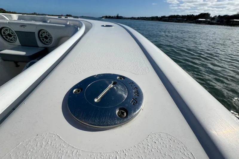 Slide: The Image of 2020 Tidewater 280 CC Adventure boat deck with waste cap, on calm water. - 26