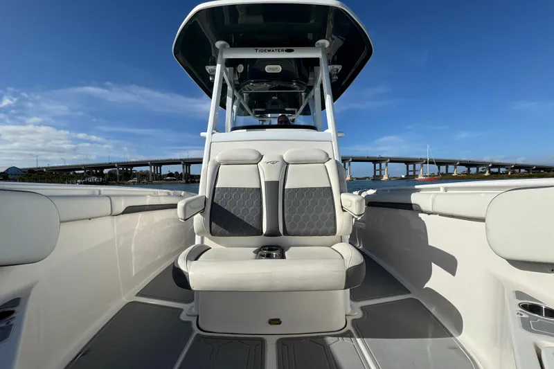 Slide: The Image of 2020 Tidewater 280 CC Adventure boat interior with seating, under clear blue sky. - 28
