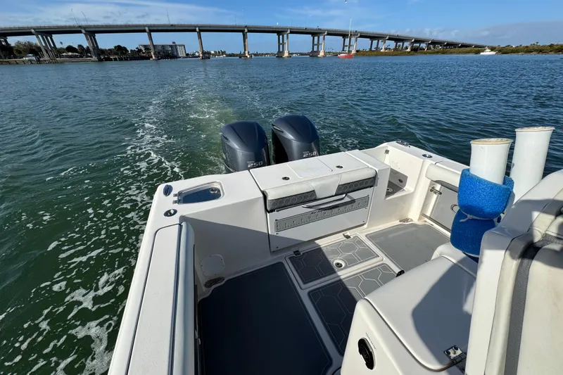 Slide: The Image of 2020 Tidewater 280 CC Adventure boat cruising under a bridge on a sunny day. - 29