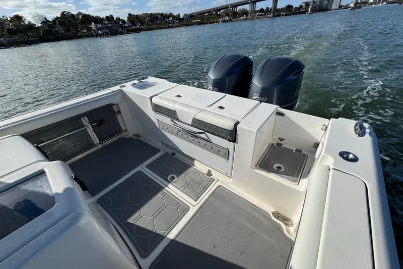 Slide: The Image of 2020 Tidewater 280 CC Adventure boat with dual 250 engines on a scenic waterway. - 30