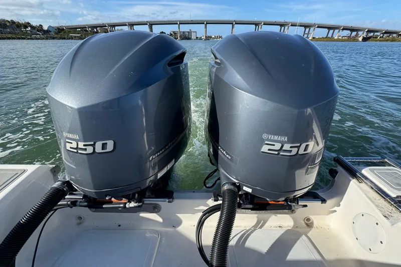 Slide: The Image of Twin Yamaha 250 engines on a 2020 Tidewater 280 CC Adventure boat, cruising under a bridge. - 32