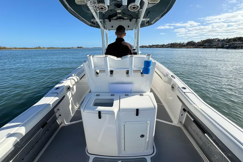 Slide: The Image of 2020 Tidewater 280 CC Adventure boat on calm water, viewed from the rear. - 34