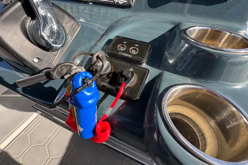 Slide: The Image of Control panel of 2020 Tidewater 280 CC Adventure boat with keys and cup holders. - 44