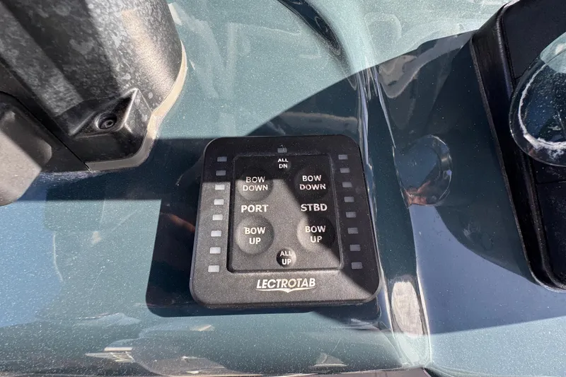 Slide: The Image of Control panel on 2020 Tidewater 280 CC Adventure boat, featuring Lectrotab trim tab switches. - 45