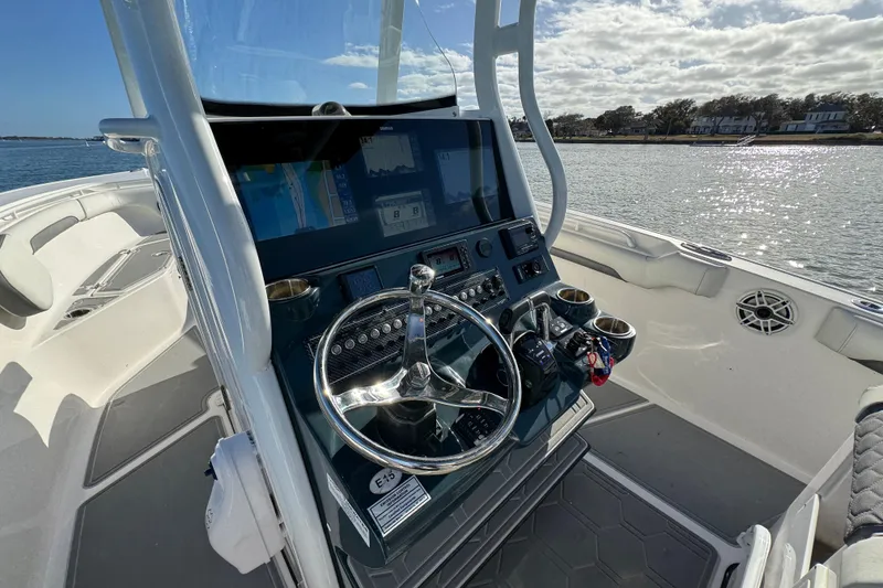 Slide: The Image of 2020 Tidewater 280 CC Adventure boat helm with modern controls and ocean view. - 46