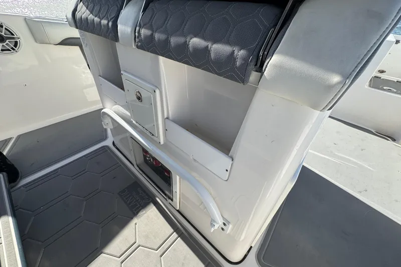 Slide: The Image of 2020 Tidewater 280 CC Adventure boat interior with cushioned seating and storage compartments. - 51