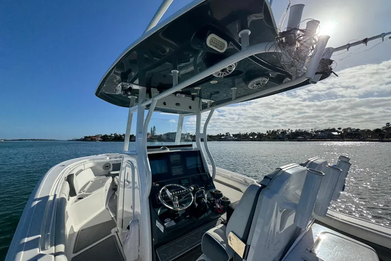 Slide: The Image of 2020 Tidewater 280 CC Adventure boat on calm water, featuring modern helm and seating. - 52