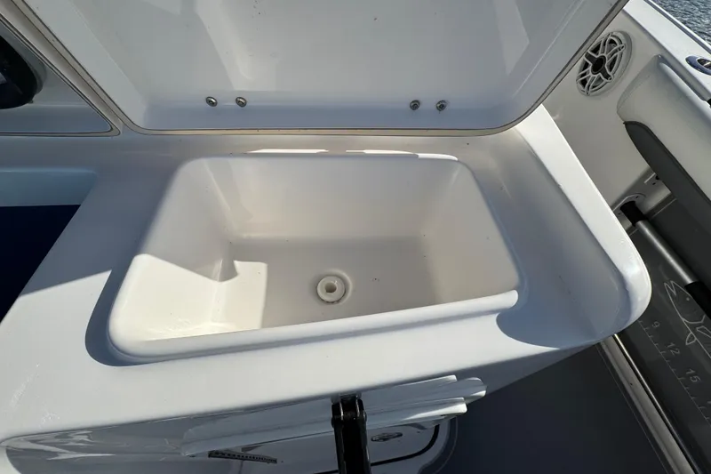 Slide: The Image of Open storage compartment on 2020 Tidewater 280 CC Adventure boat. - 57