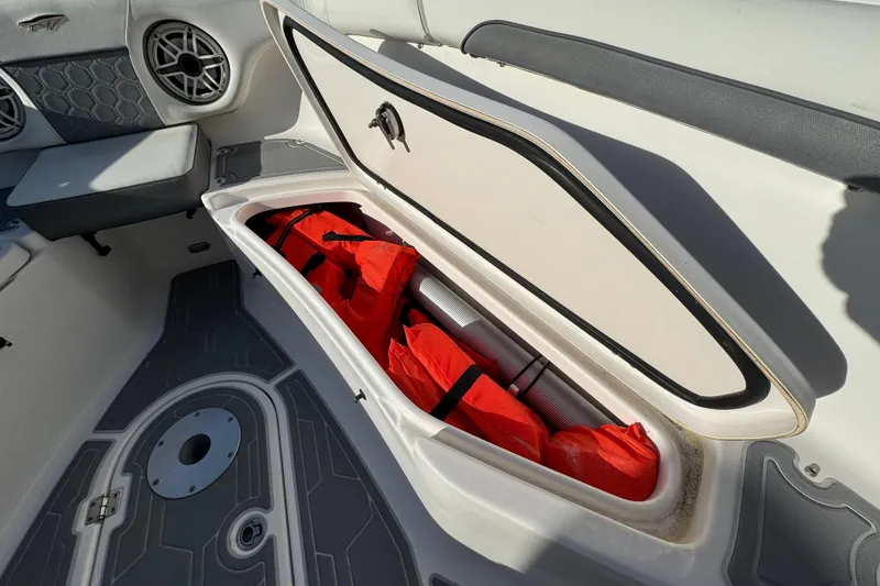 Slide: The Image of Open storage compartment on 2020 Tidewater 280 CC Adventure boat with life jackets inside. - 62