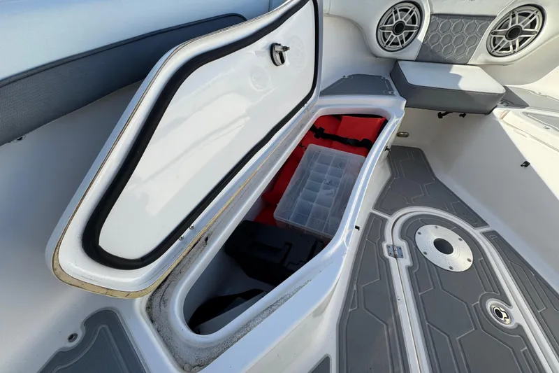 Slide: The Image of Open storage compartment on 2020 Tidewater 280 CC Adventure boat with organized gear. - 63