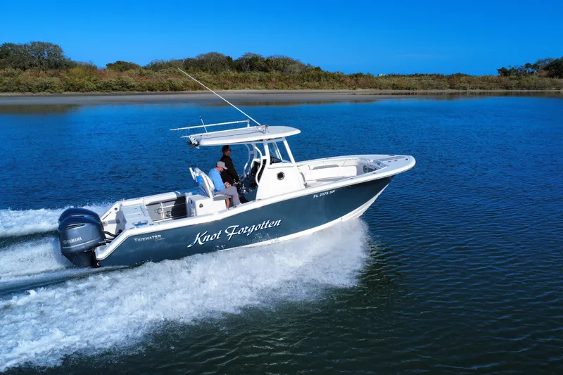 Slide: The Image of 2020 Tidewater 280 CC Adventure boat cruising on a serene blue lake. - 7