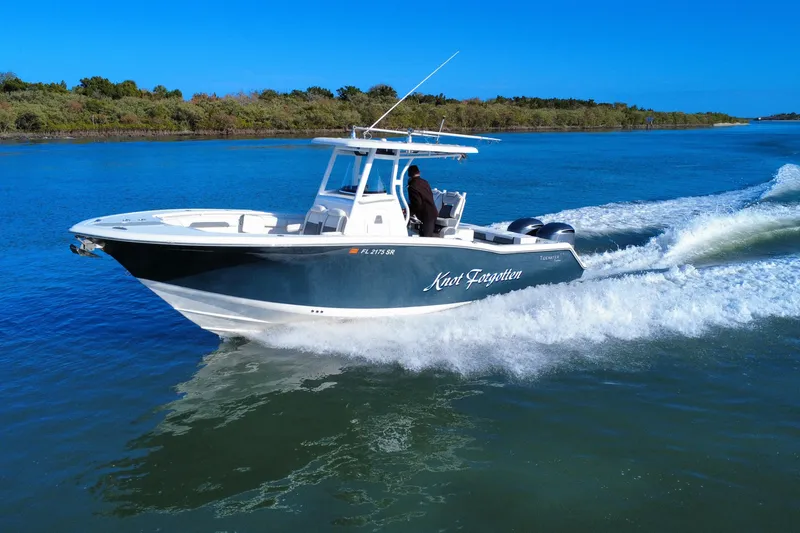 Slide: The Image of 2020 Tidewater 280 CC Adventure boat cruising on a sunny day. - 9