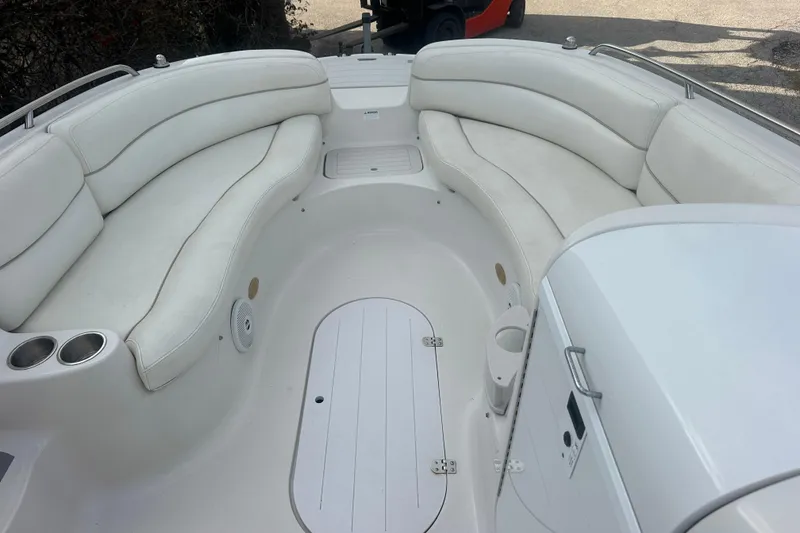 Slide: The Image of 2004 Vectra S-215 boat interior with white seating and cup holders. - 6