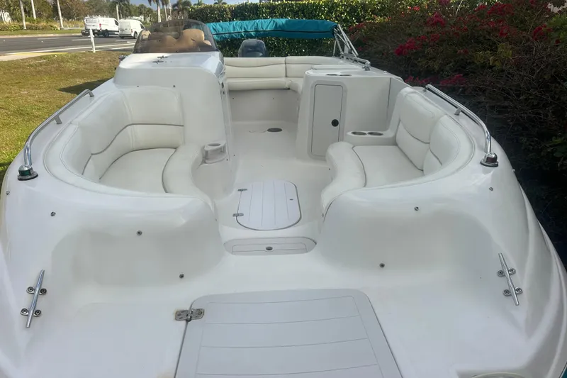 Slide: The Image of 2004 Vectra S-215 boat interior with white seating and open deck layout. - 7