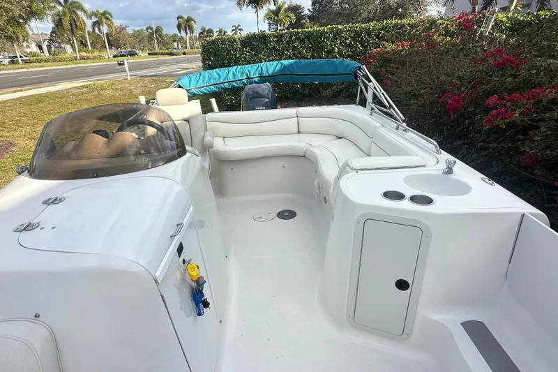 Slide: The Image of 2004 Vectra S-215 boat interior with white seating and blue canopy. - 8