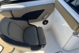 Slide: The Image of 2024 Sea Ray SPX 230 boat interior with cushioned seating and sleek design. - 10