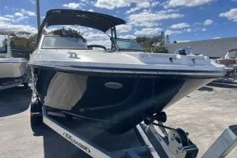 Slide: The Image of 2024 Sea Ray SPX 230 boat on trailer under blue sky. - 3