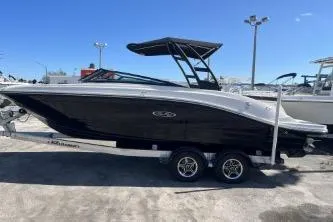 Slide: The Image of 2024 Sea Ray SPX 230 boat on trailer, sleek black design, outdoor display. - 4