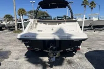 Slide: The Image of 2024 Sea Ray SPX 230 boat rear view in a sunny marina setting. - 6