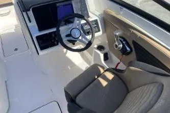 Slide: The Image of 2024 Sea Ray SPX 230 boat interior with steering wheel and control panel. - 8