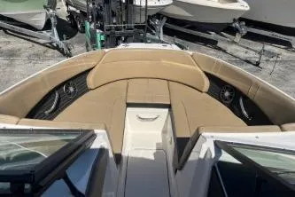 Slide: The Image of 2024 Sea Ray SPX 230 boat interior with tan seating and sleek design. - 9