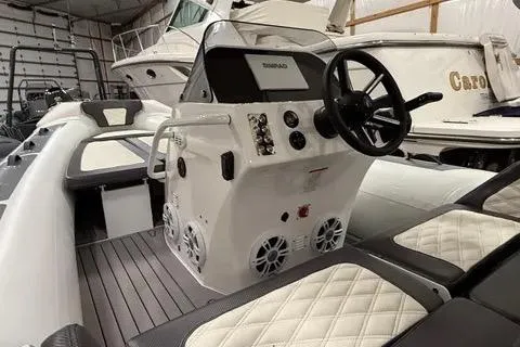 Slide: The Image of 2024 Highfield Sport 520 boat interior with steering console and cushioned seating. - 11