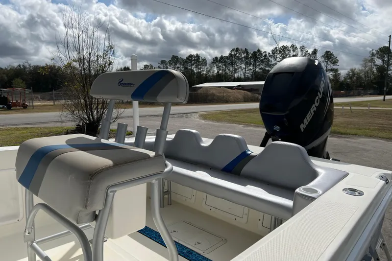 Slide: The Image of 2011 Renegade OF 23 boat with Mercury engine, featuring blue and gray seating. - 12