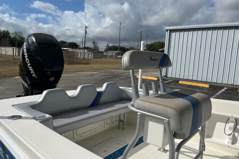Slide: The Image of 2011 Renegade OF 23 boat with Mercury engine, featuring cushioned seating and storage. - 14