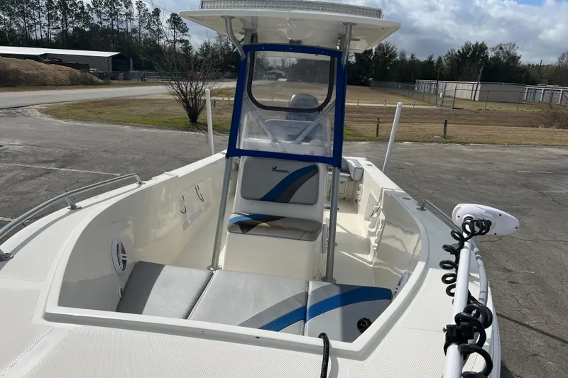 Slide: The Image of 2011 Renegade OF 23 boat with blue accents, parked outdoors. - 20