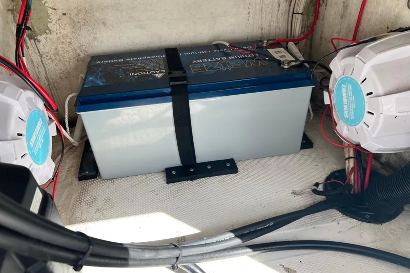Slide: The Image of Battery setup in a 2011 Renegade OF 23 boat with wiring and speakers. - 23