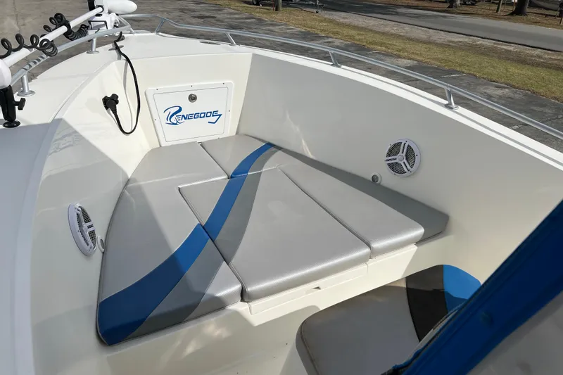 Slide: The Image of Renegade OF 23 boat interior, 2011 model, featuring cushioned seating and speakers. - 24