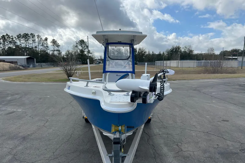 Slide: The Image of 2011 Renegade OF 23 boat on trailer, parked outdoors under cloudy sky. - 3