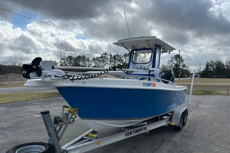 Slide: The Image of Blue 2011 Renegade OF 23 boat on trailer under cloudy sky. - 4