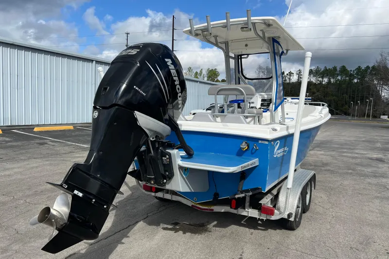 Slide: The Image of 2011 Renegade OF 23 boat with Mercury engine on trailer, parked outdoors. - 8