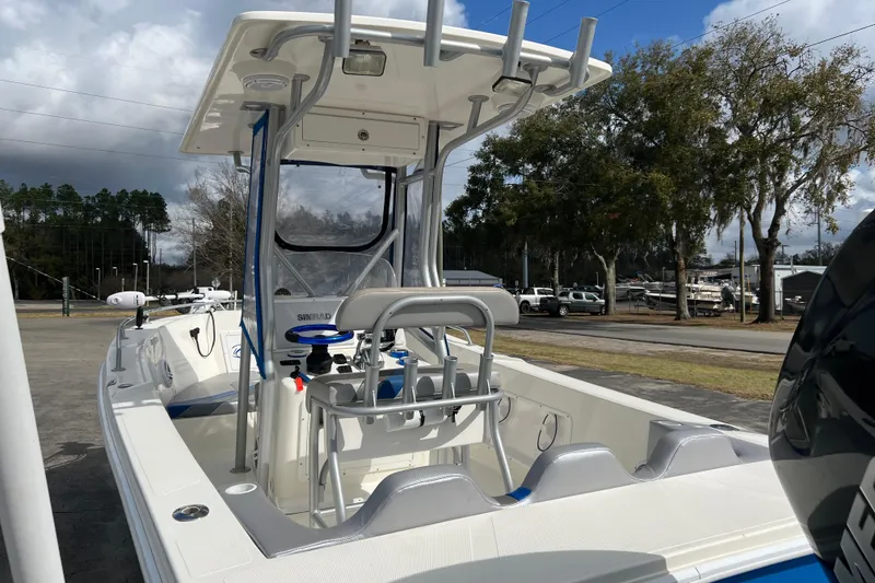 Slide: The Image of 2011 Renegade OF 23 boat with center console and seating, parked outdoors. - 9
